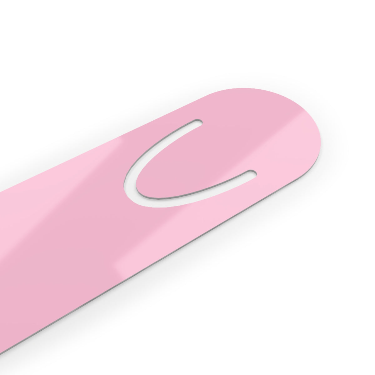 A close-up of a glossy light pink plastic tool, likely a nail file or manicure scraper, featuring a curved cutout slot, shown on a clean white background.